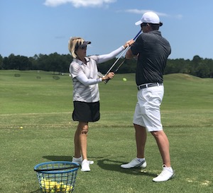 Photo - LPGA golf instructor giving a golf lesson to man