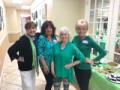 Photo of the hostesses of the St. Patricks Day pot luck dinner that are outfitted in green