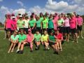Group photo of Ladies golf competitors wearing vivid team colors